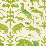 Detail of fabric in a playful animal and botanical print in green and blue on a cream field.
