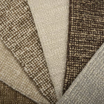 Close-up of textured carpet swatches in beige, brown, and gray.