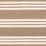 Broadloom carpet in a wide stripe in light brown and cream with dark brown accent stripes. 