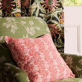 Floral-patterned cushions on a chair with a door in the background