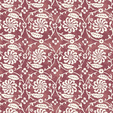 Wallpaper with white floral and leaf design on a wine-red background