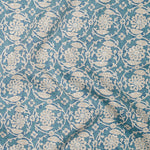 Floral patterned fabric with white flowers on a blue background