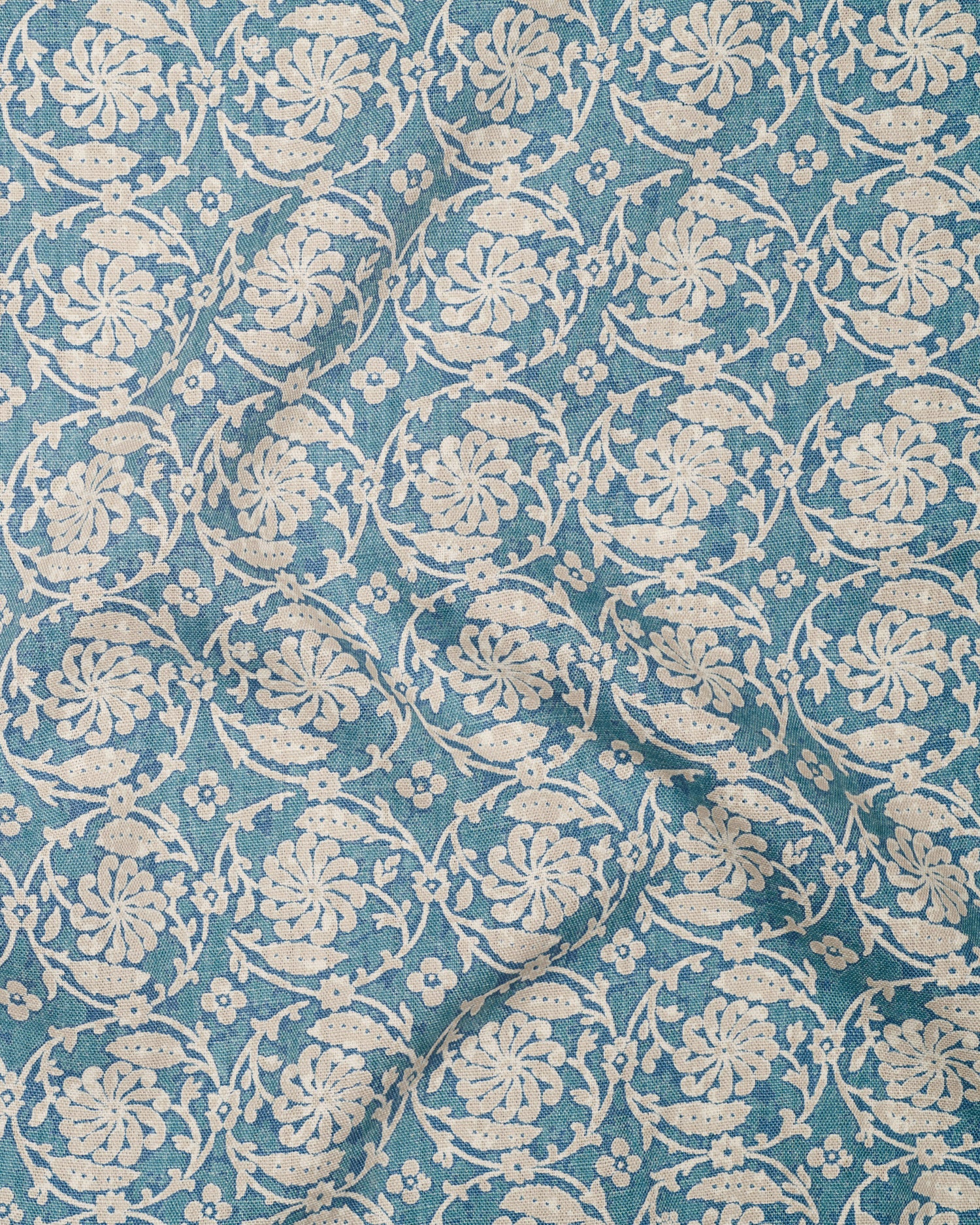 Floral patterned fabric with white flowers on a blue background