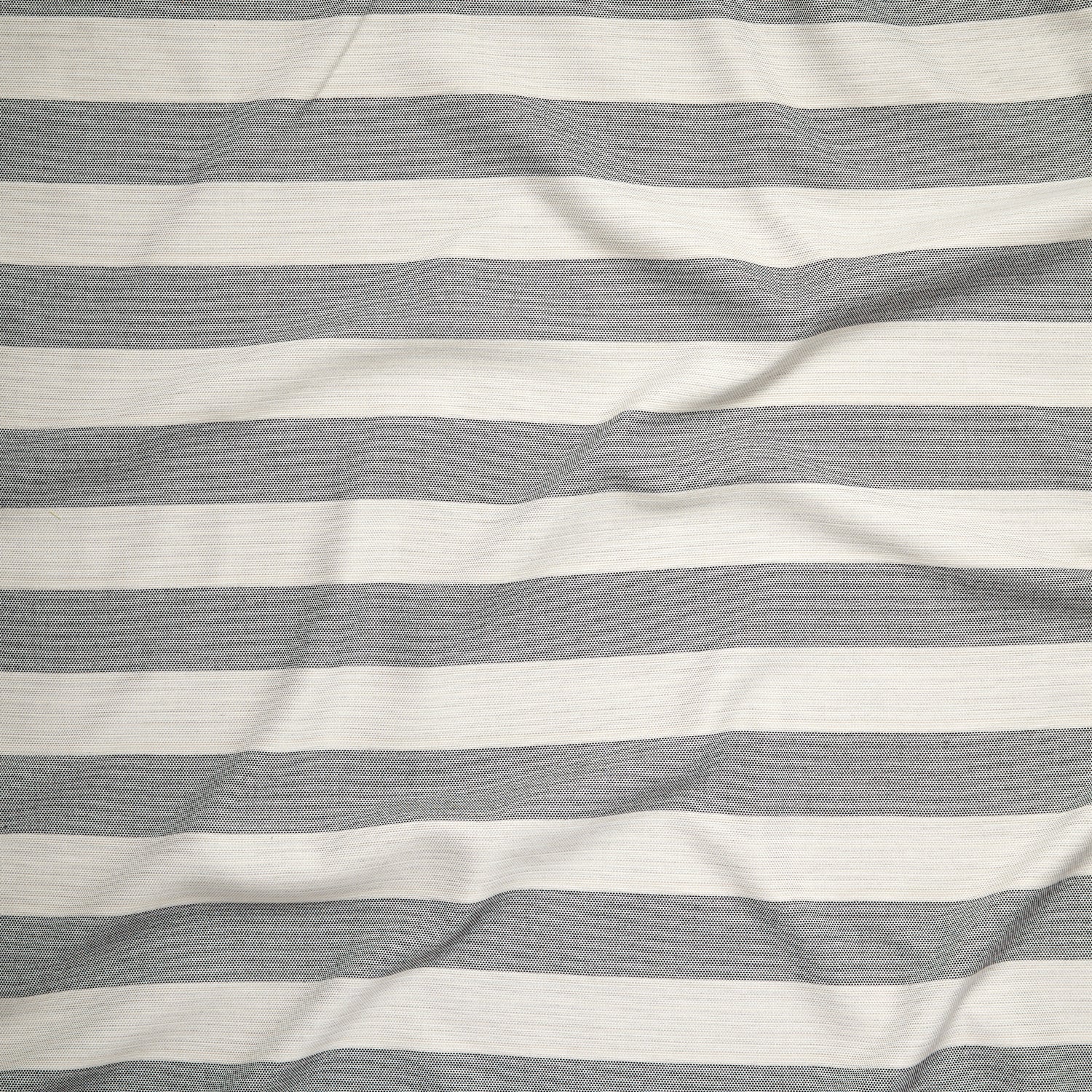 Close up of gently draped woven Indoor-Outdoor fabric with wide stripes in white and charcoal grey.