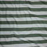 Close up of gently draped woven Indoor-Outdoor fabric with wide stripes in dark green and light blue.