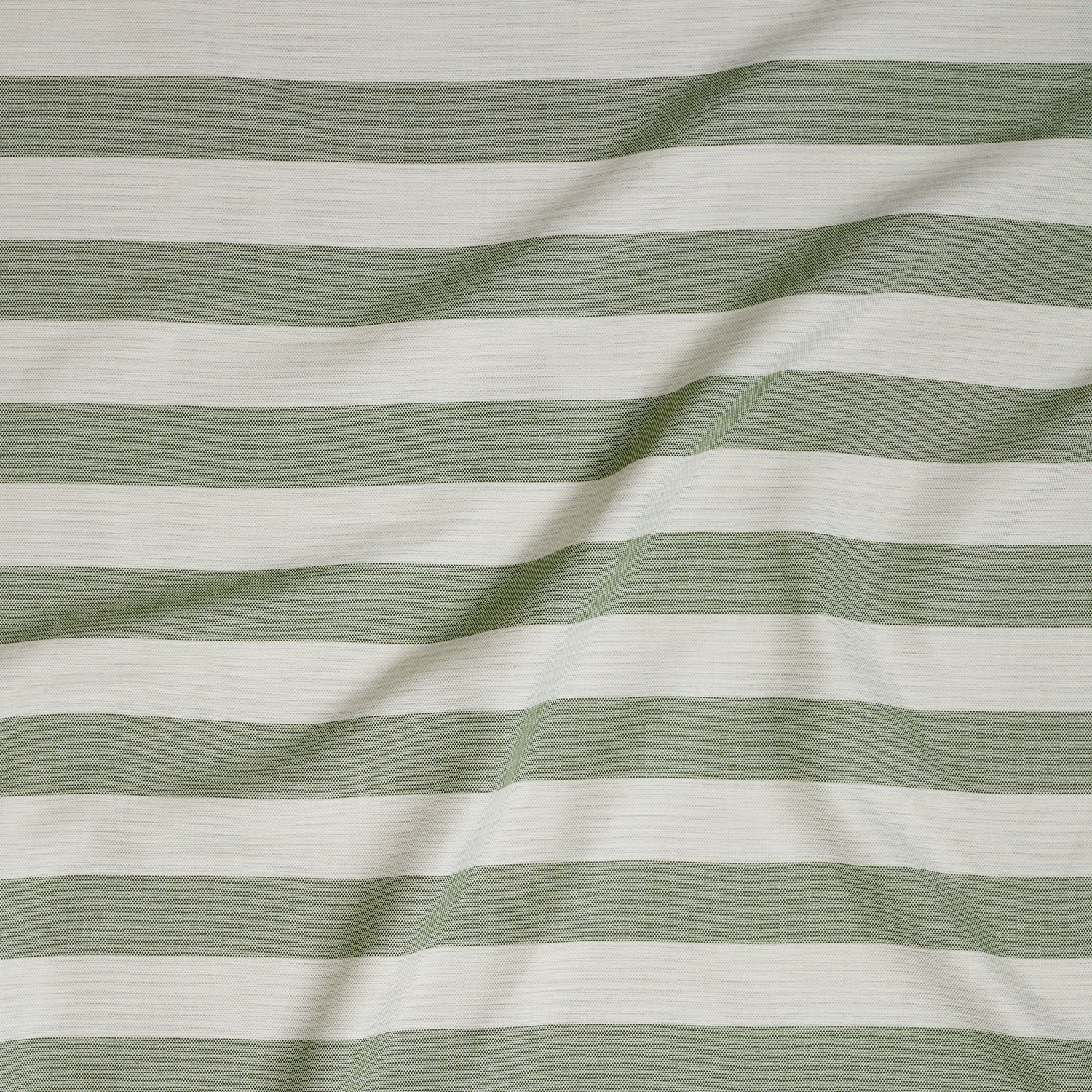 Close up of gently draped woven Indoor-Outdoor fabric with wide stripes in white and green.