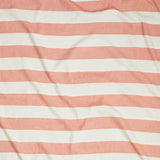 Close up of gently draped woven Indoor-Outdoor fabric with wide stripes in white and coral red