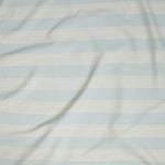 Close up of gently draped woven Indoor-Outdoor fabric with wide stripes in white and light blue.