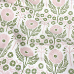 Draped Printed linen in an arts and crafts style floral pattern in pink and green on white. 