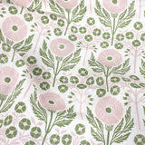 Draped Printed linen in an arts and crafts style floral pattern in pink and green on white. 