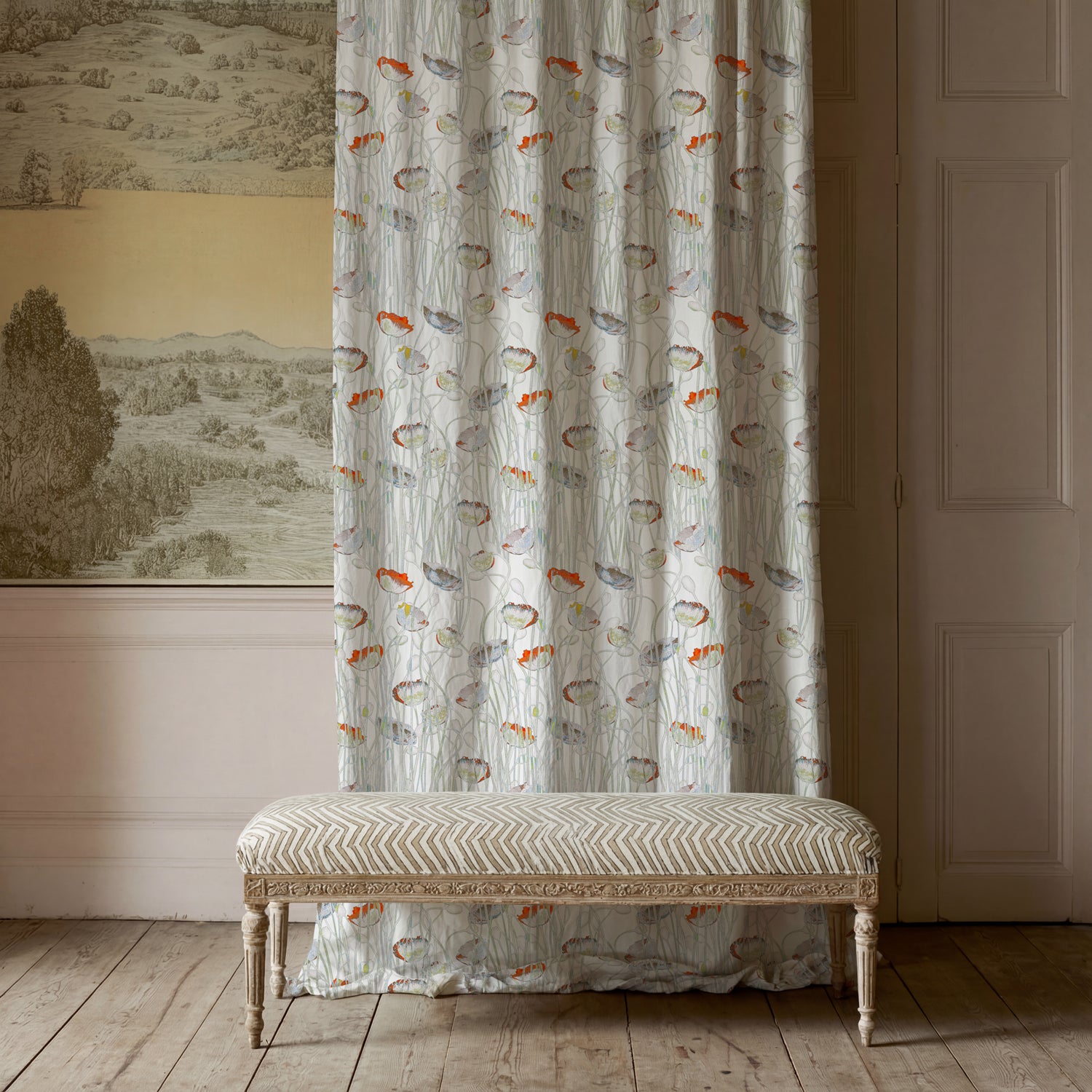 Decorative bench in front of a curtain with a patterned wall and door in the background