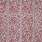 Printed fabric detail in a geometric rhythmic stripe in a warm pink with a light green accent. 