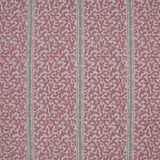Printed fabric detail in a geometric rhythmic stripe in a warm pink with a light green accent. 
