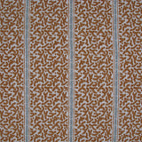 Printed fabric detail in a geometric rhythmic stripe in warm brown with a light blue accent