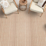 Textural herringbone area rug with wooden and white side chairs with rattan side stools.