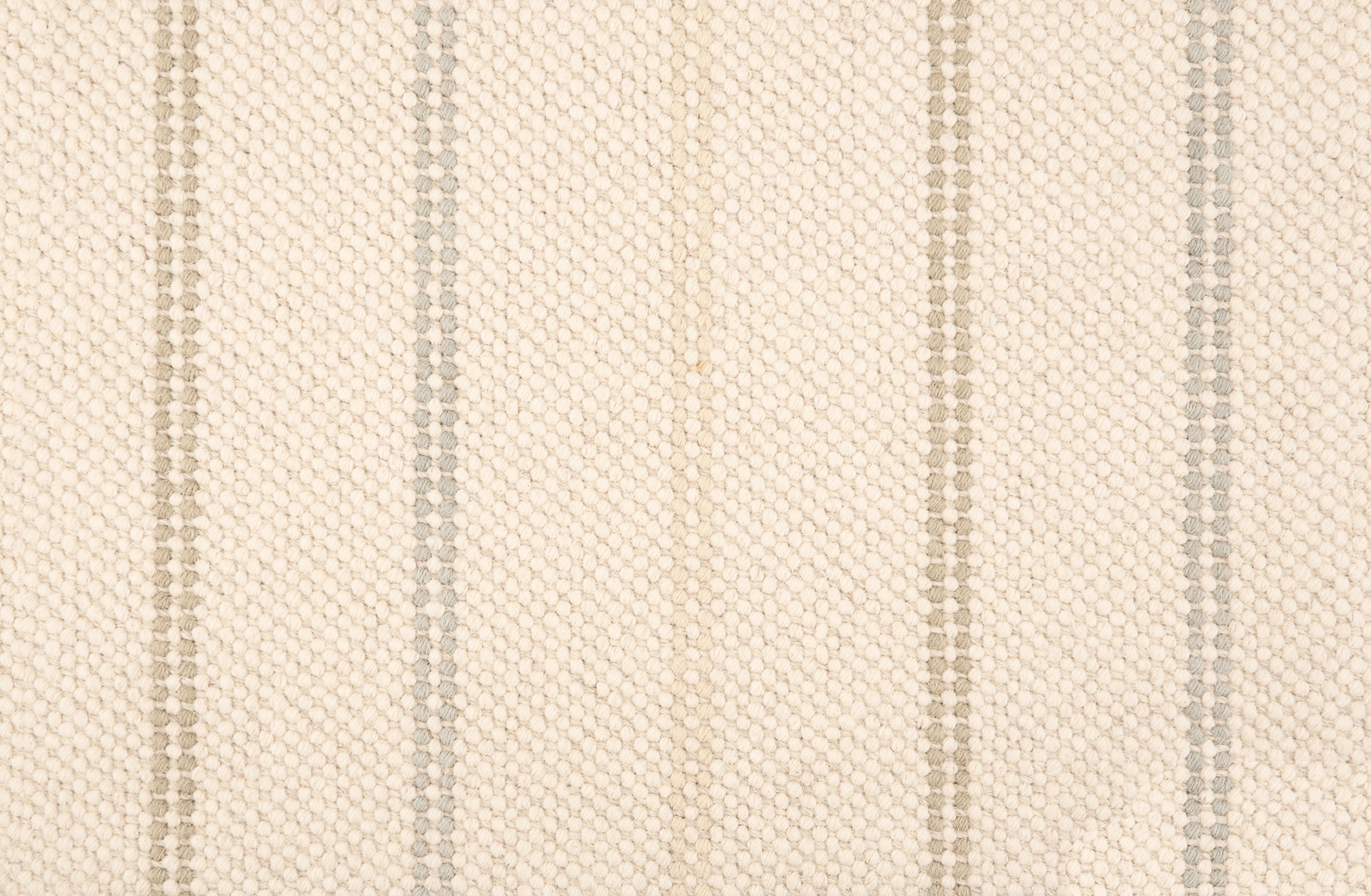 Broadloom carpet in a neutral with widely spaced stripes in shades of tan and grey.