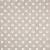 Detail of fabric in a playful dot print in gray and white on a gray field.