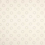 Detail of fabric in a playful dot print in charcoal on a cream field.