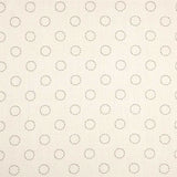Detail of fabric in a playful dot print in charcoal on a cream field.