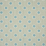 Detail of fabric in a playful dot print in blue and white on a gray field.