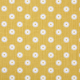 Detail of fabric in a playful dot print in white and gray on a mustard field.