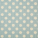 Detail of fabric in a playful dot print in white, gray and tan on a blue field.