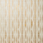 Detail of wallpaper in a geometric grid print in metallic gold, cream and white.