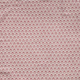 Detail of fabric in a small-scale floral grid print in red on a cream field.