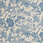 Detail of a linen fabric in a carp and leaf pattern in blue on a beige field.
