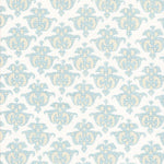 Detail of fabric in a repeating damask print in blue and yellow on a white field.