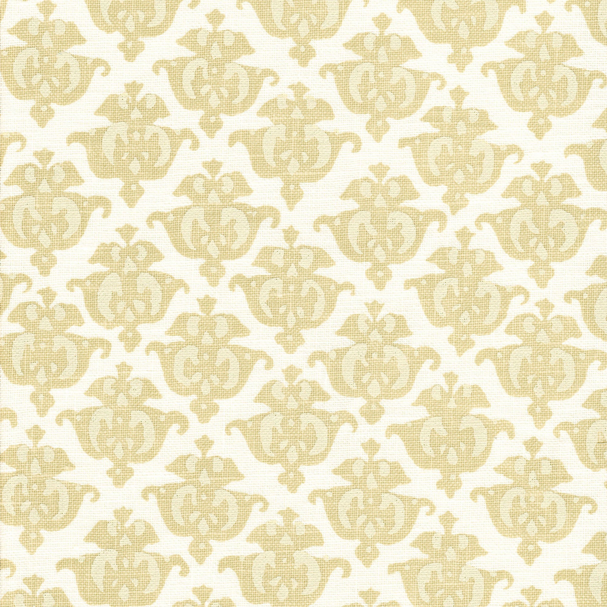 Detail of fabric in a repeating damask print in tan and cream on a white field.