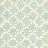 Detail of fabric in a repeating damask print in blue and tan on a cream field.