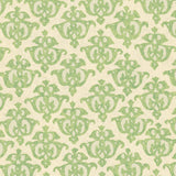 Detail of wallpaper in a repeating damask print in green on a cream field.
