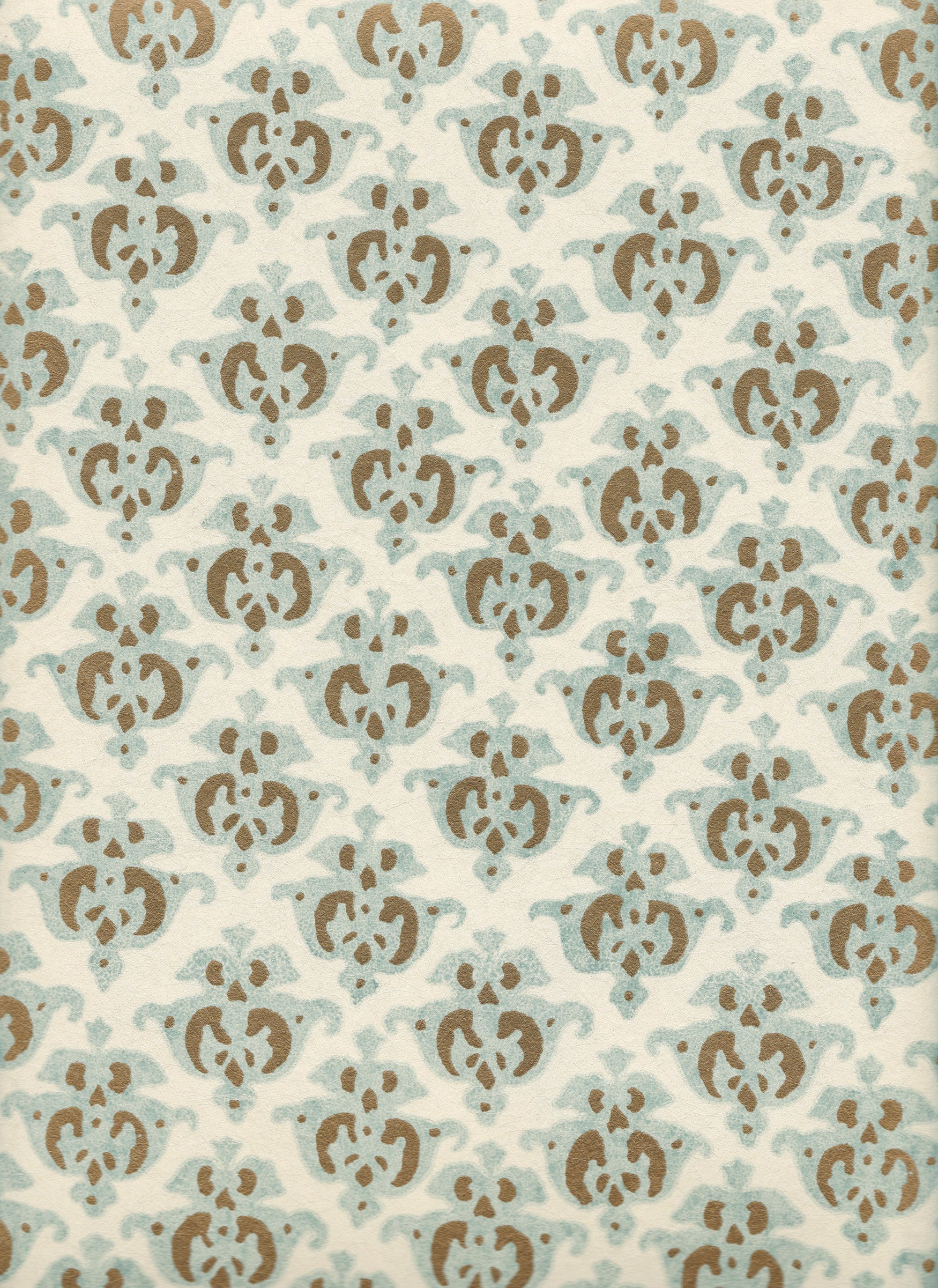 Detail of wallpaper in a repeating damask print in light blue and brown on a cream field.