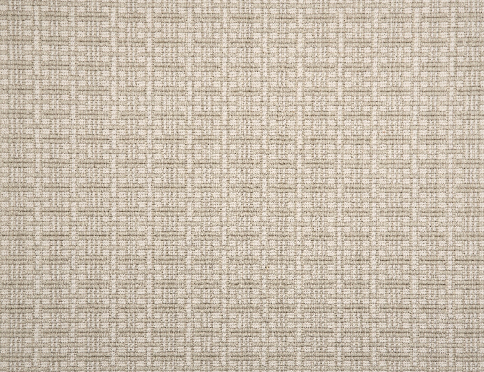 A close-up of broadloom carpet with a textured basketweave pattern in warm cream and oatmeal.