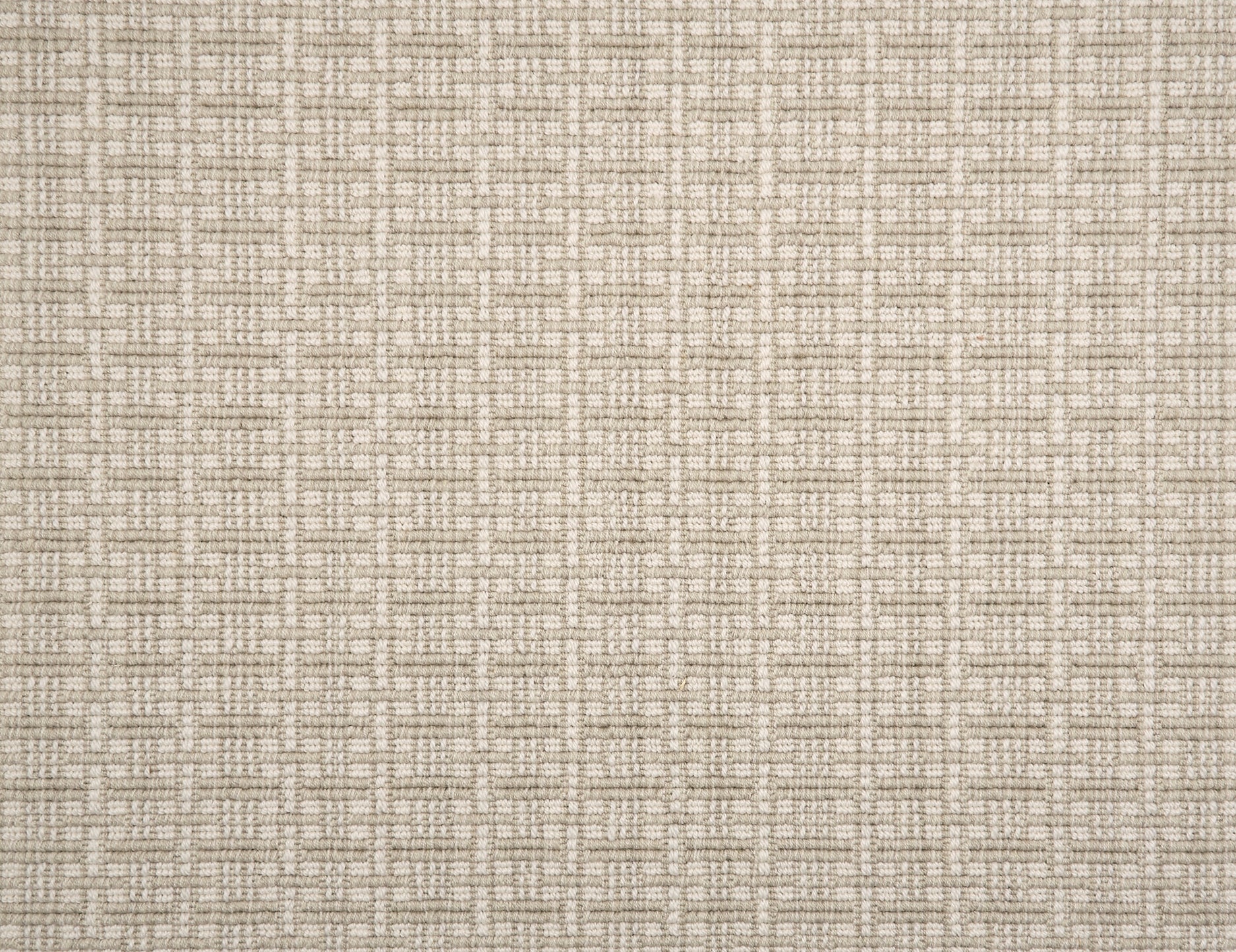 A close-up of broadloom carpet with a textured basketweave pattern in warm cream and oatmeal.