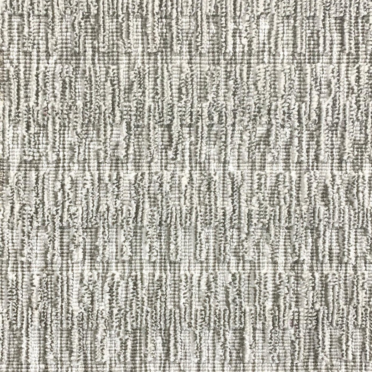 A close-up of a broadloom rug in a vertical ribbed pattern  in a neutral mix of off-white, and gray. 