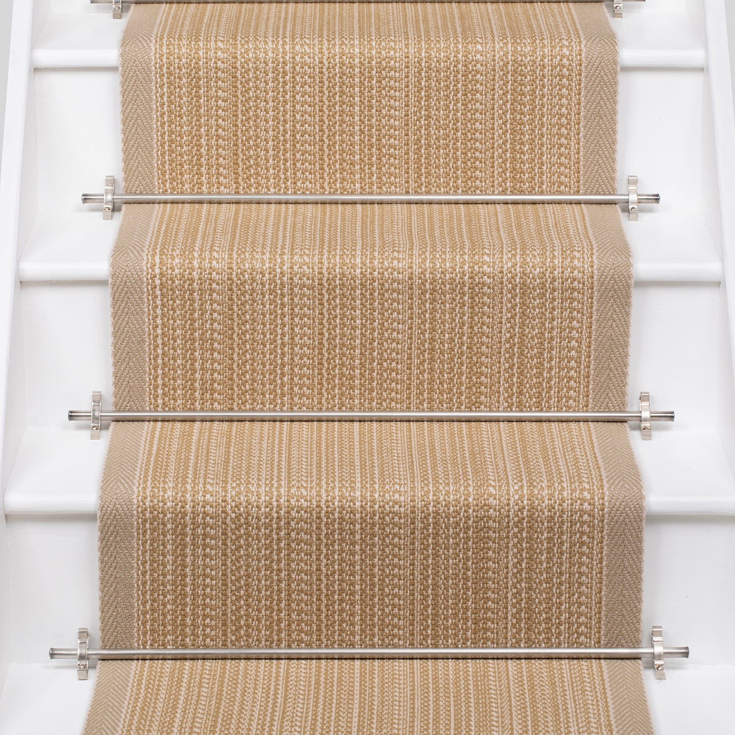 White stairs with textural striped runner in warm tan with metal stair rails. 