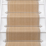 White stairs with textural striped runner in warm tan with metal stair rails. 