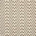 Flatweave rug with a zigzag pattern in beige and brown on a neutral background