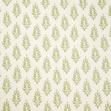 Detail of fabric in a repeating leaf pattern in light green on a cream field.
