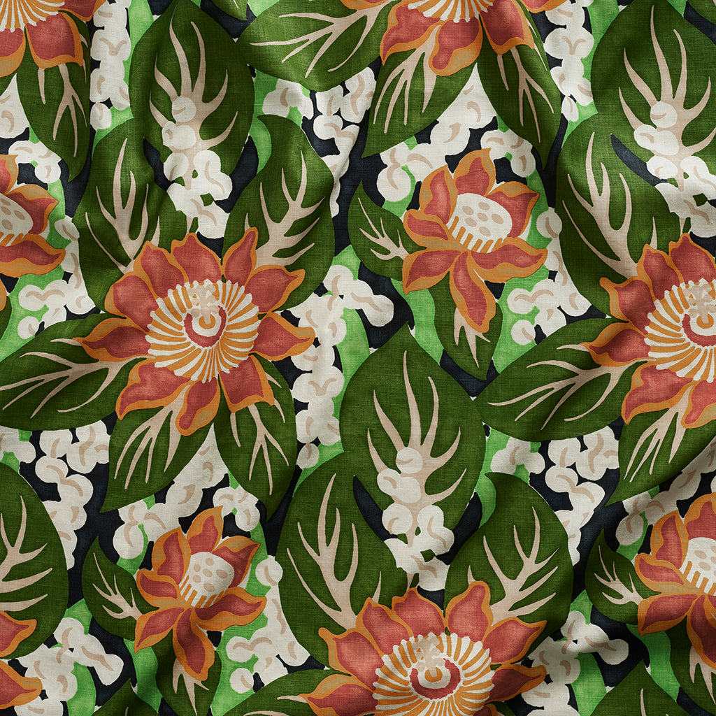 Close up of tropical floral gently draped printed linen featuring orange and red blossoms with creamcenters, dark green leaves on a navy blue background.