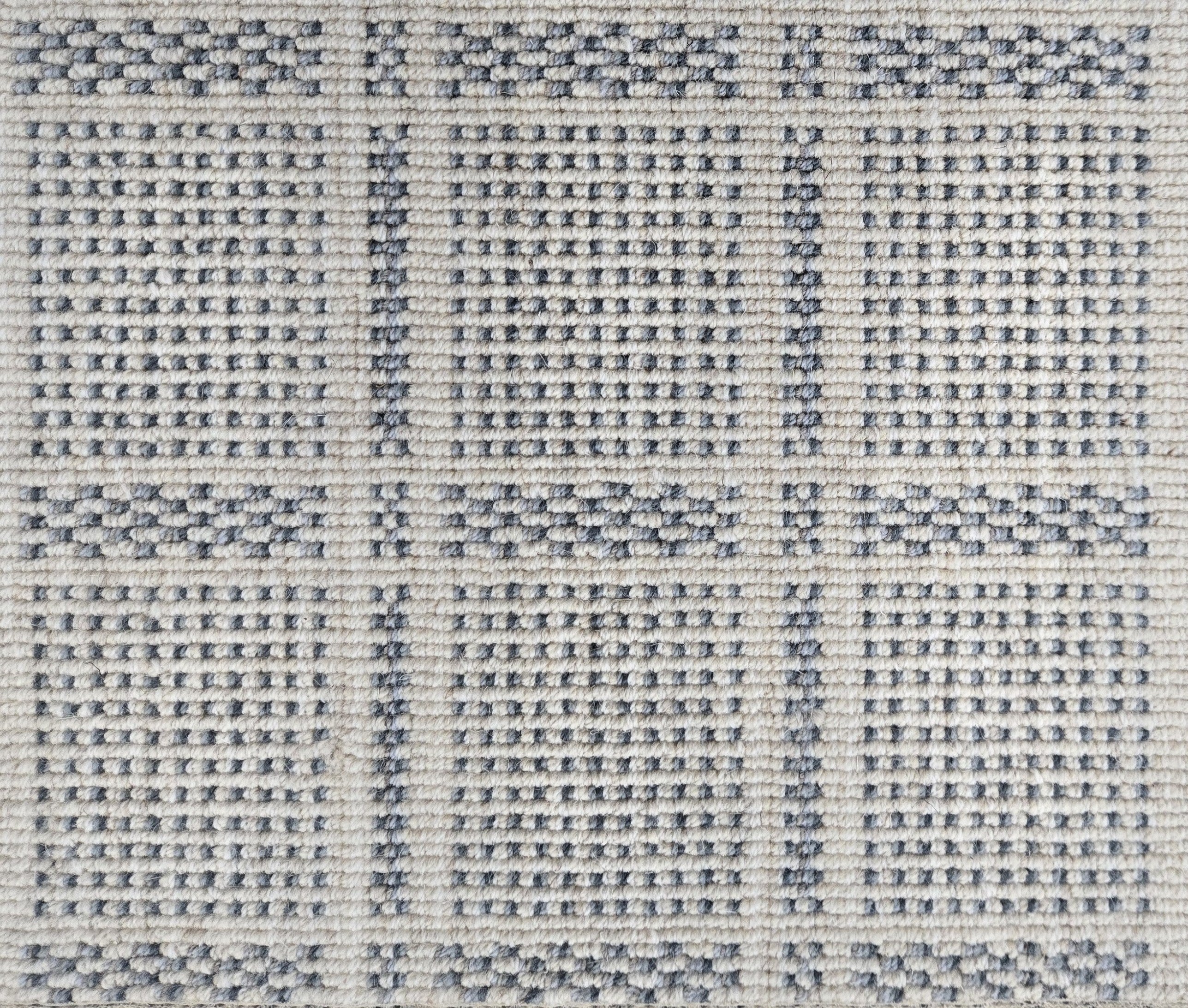 Broadloom carpet in check pattern in shades of blue with cream. 
