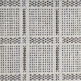 Broadloom carpet in check pattern in shades of brown and blue with cream. 