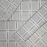 Broadloom carpet samples in a plaid pattern in a range of neutral colors. 
