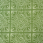 Detail of fabric in a damask lattice print in white on a green field.