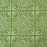 Detail of fabric in a damask lattice print in white on a green field.