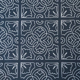 Detail of fabric in a damask lattice print in white on a navy field.