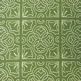 Detail of fabric in a damask lattice print in white on a green field.