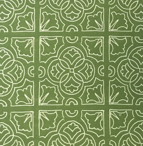 Detail of fabric in a damask lattice print in white on a green field.